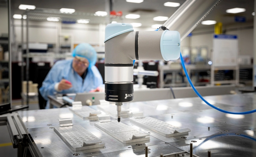 Robot With Employee In Background